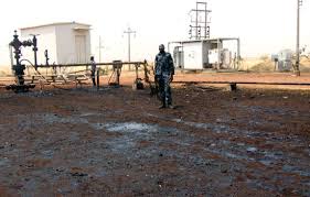 South Sudanese army soldiers take cover from the sun in the town of Paloch where one of South Sudan's last working petroleum facilities is located, on March 2, 2014. Fighting in South Sudan has cut production from the country's lifeline oilfields by about 29 percent, the press secretary to President Salva Kiir said in Khartoum today. AFP PHOTO / ANDREI PUNGOVSCHI (Photo credit should read ANDREI PUNGOVSCHI/AFP/Getty Images)