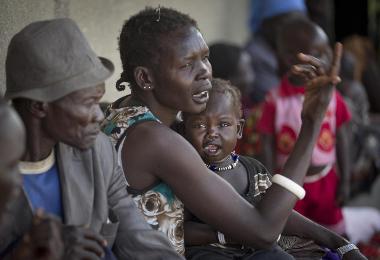 Displaced people who fled from recent fighting in Bor, South Sudan, queue outside a clinic run by MSF set up in a school building in the town of Awerial, on Jan. 2, 2014 (AP Photo/Ben Curtis)