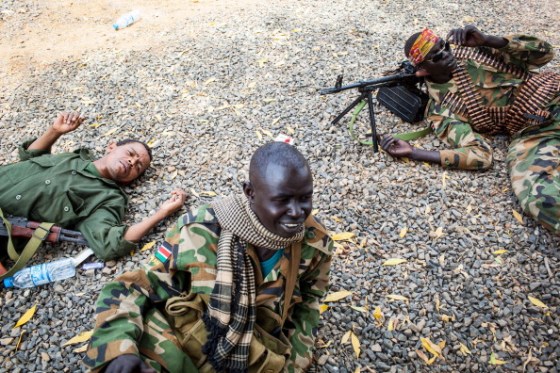 South Sudanese army soldiers take cover from the sun in the town of Paloch where one of South Sudan's last working petroleum facilities is located, on March 2, 2014. Fighting in South Sudan has cut production from the country's lifeline oilfields by about 29 percent, the press secretary to President Salva Kiir said in Khartoum today. AFP PHOTO / ANDREI PUNGOVSCHI (Photo credit should read ANDREI PUNGOVSCHI/AFP/Getty Images)