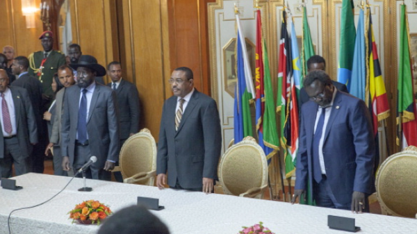 Salva Kiir (L), President of South Sudan, Riek Machar (R), SPLM Opposition leader, and Ethiopian Prime Minister Hailemariam Desalegn (C) attend a press conference to sign the Cessation of Hostilities treaty over the war in South Sudan on May 9, 2014 in Addis Ababa. South Sudan's president and rebel chief signed a ceasefire deal Friday vowing to end nearly five months of civil war, with the US urging both sides to 'swiftly' implement their promises. Salva Kiir and rebel boss Riek Machar, who shook hands and then prayed together, 'agreed that immediately all hostile activities will stop within 24 hours from the signing of this agreement', said head mediator Seyoum Mesfin, from the East African regional bloc IGAD. AFP PHOTO / ZACHARIAS ABUBEKER (Photo credit should read ZACHARIAS ABUBEKER/AFP/Getty Images)