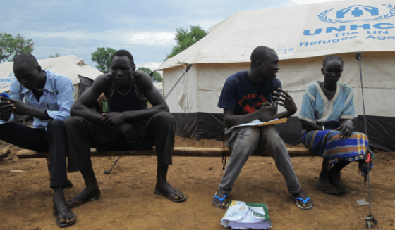 Gatwech interviewing a woman under her tent in Kule refugee camp(Photo: Gatwech)