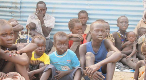 These orphaned children received food from WFP after a humanitarian mission arrived in the town of Pibor in South Sudan's Jonglei state on 3 January 2012. (Photo: WFP/Rehan Zahid)