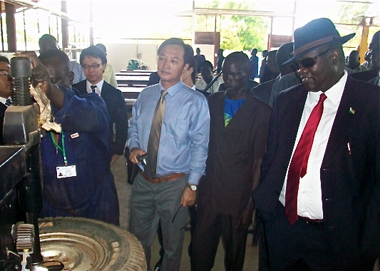 Vice President Riek Machar (right) listens to an automobile repairs instructor at MTC Juba during the launching ceremony, October 29