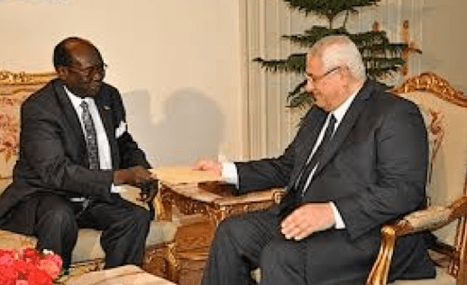 Dr. Benjamin hands-over a letter from the South Sudanese President Salva Kiir Mayardit to his counter-part Mansour [Photo: Ajang Monychol]