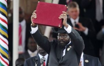 Salva Kiir, displays the transitional constitution after forcefully signing it into law in 2011(Photo: Reuters)