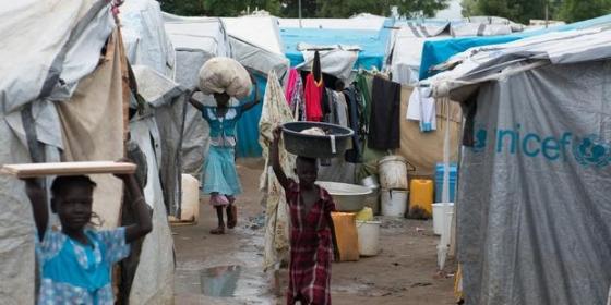 Young girls carry luggage in an United Nations Mission in South Sudan (UNMISS) IDP...