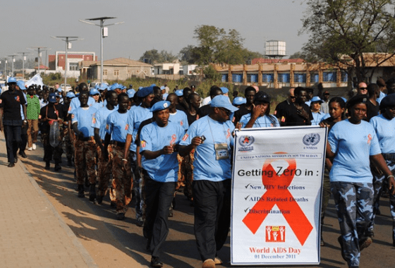 Secondary Roles UNMISS staff members marching during the 2011 World AIDS Day celebrations jointly with organized forces of ...