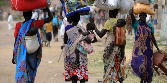 Displaced South Sudanese women walk towards the United Nations Mission in South Sudan (UNMISS) base in Malakal on January 12, 2014. About 32,000 refugees have fled to Uganda and a total of around 10,000 others have gone to Ethiopia and Kenya, while more than 350,000 are internally displaced within South Sudan, the United Nations says.  AFP PHOTO/SIMON MAINA        (Photo credit should read SIMON MAINA/AFP/Getty Images)