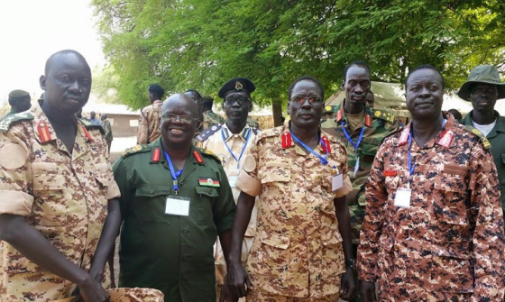 Maj. Gen. Martin Kenyi (in green) smiling comfortably in the arms of his colleagues, Maj. Gen. Peter Gatdet Yaka, Maj. Gen. James Koang Chuol Ranley and Brig. Gen. Thoi Chany at SPLM/SPLA Leadership conference in Pagak, April 2015(Photo: Nyamilepedia)